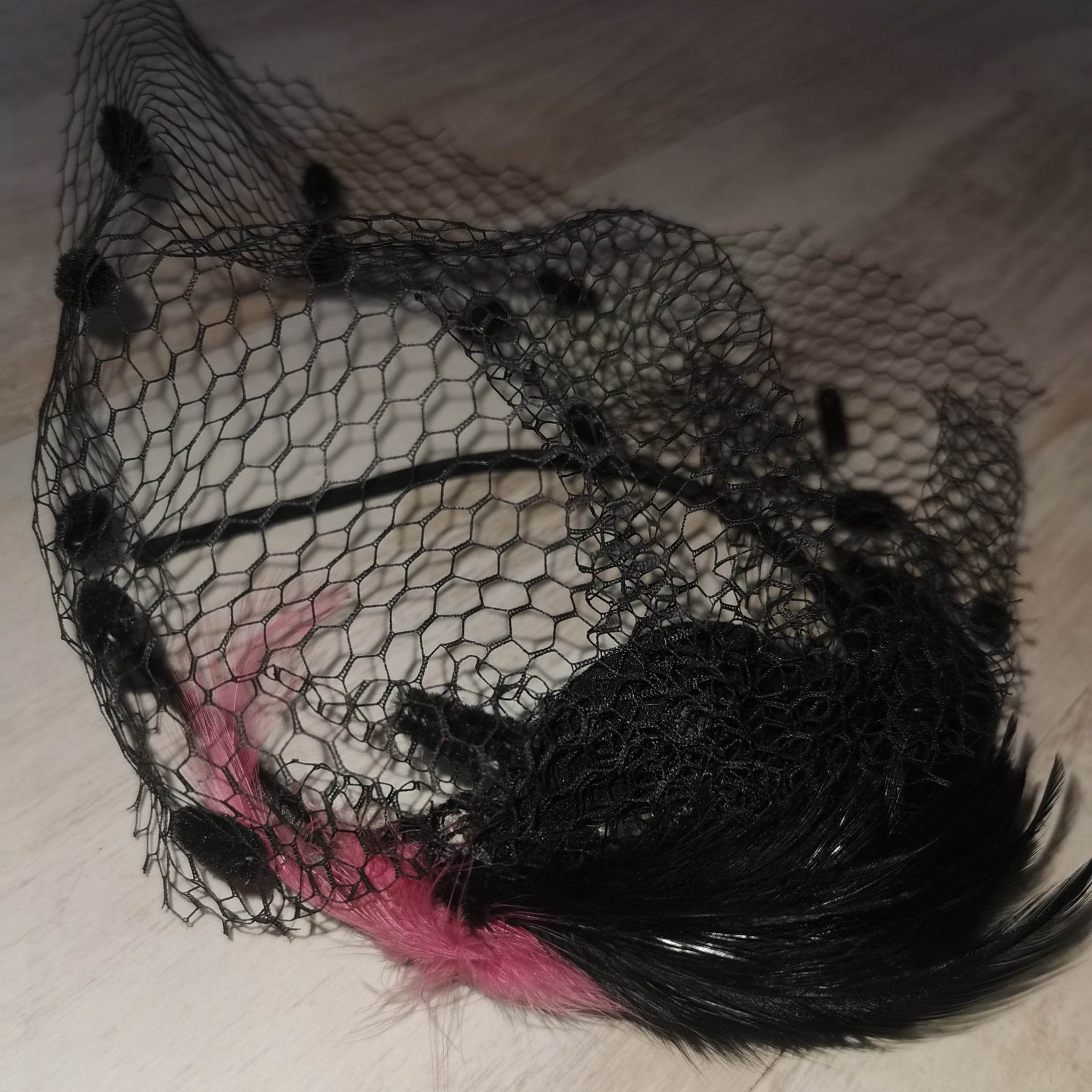 Pink and black feathered rich widow alice band with netting